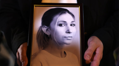 A-former-colleague-of-Roshchyna-holds-a-framed-photo-of-her-at-an-event-in-her-memory-in-Kyiv-last-October-AFP.jpg